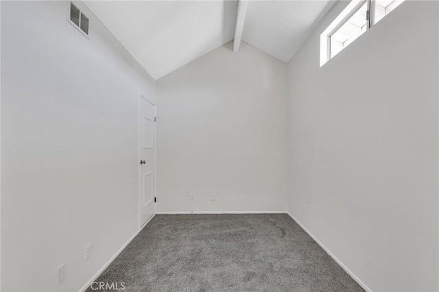 carpeted empty room featuring lofted ceiling with beams