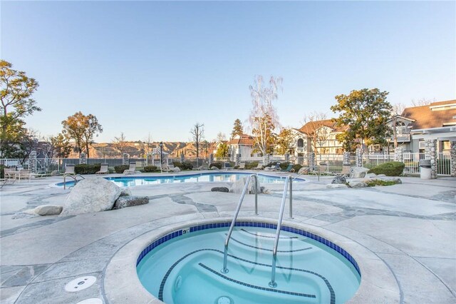 view of swimming pool featuring a community hot tub