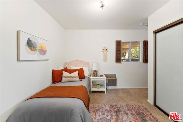 bedroom featuring light colored carpet and a closet