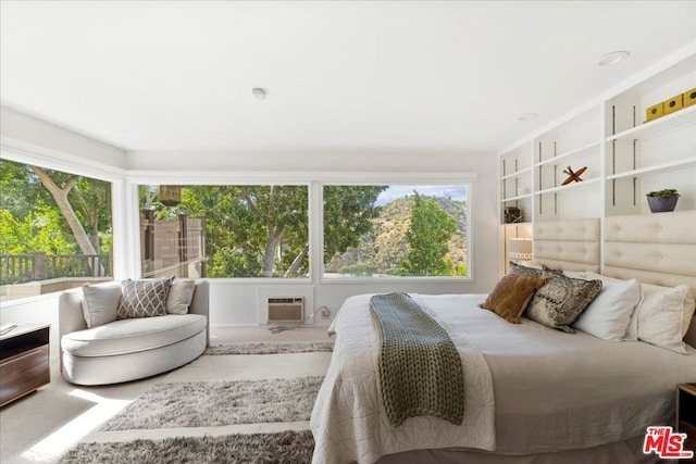 carpeted bedroom with a wall mounted AC