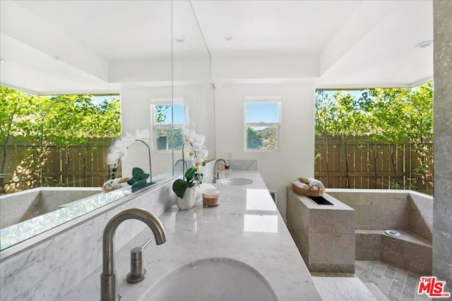 bathroom featuring vanity and a bath