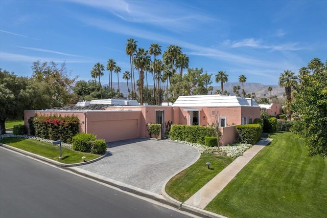 view of front of house with a front lawn and a mountain view