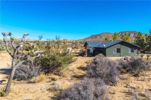 view of property exterior featuring a mountain view