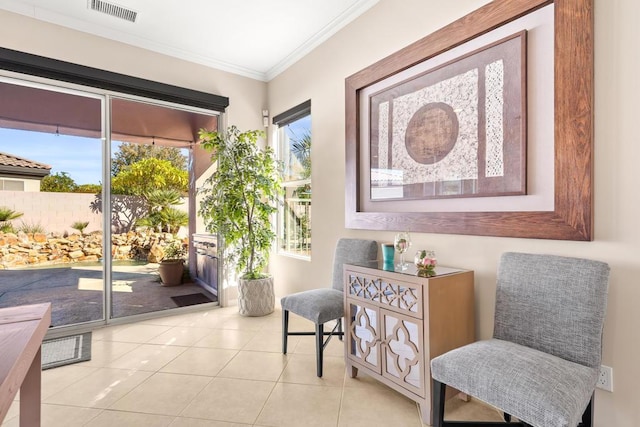 sitting room featuring crown molding and light tile patterned flooring