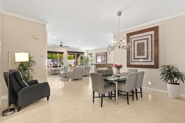 tiled dining space featuring ceiling fan with notable chandelier and ornamental molding