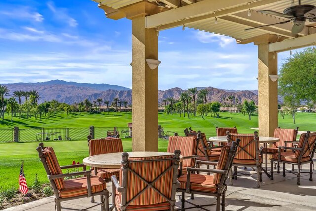 view of patio / terrace with a mountain view and ceiling fan