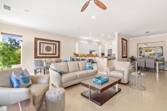 living room with ceiling fan with notable chandelier, ornamental molding, and light tile patterned floors