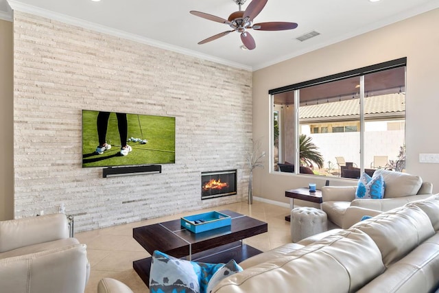 living room with a fireplace, light tile patterned floors, ceiling fan, and ornamental molding