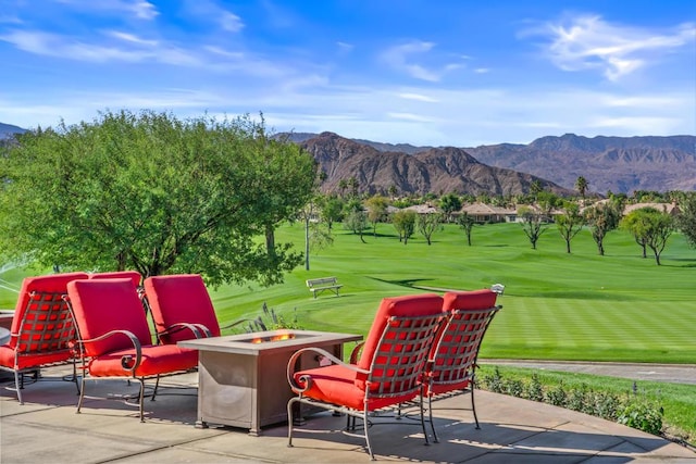 exterior space featuring a mountain view and a fire pit