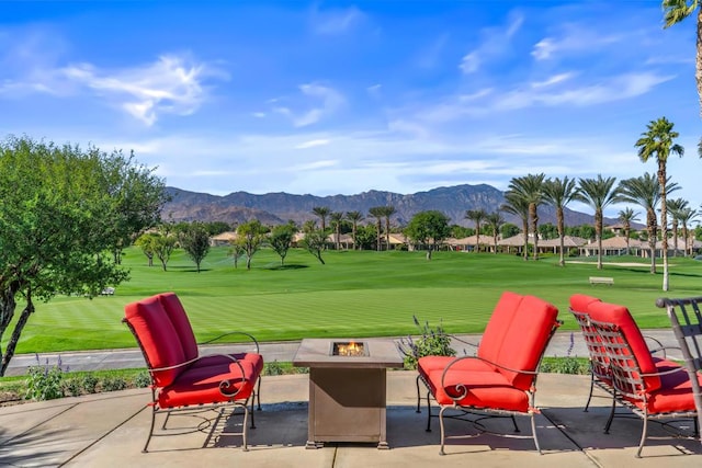 surrounding community with a patio area, a mountain view, a yard, and an outdoor fire pit