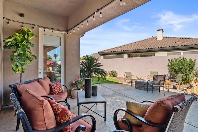 view of patio featuring an outdoor living space with a fire pit