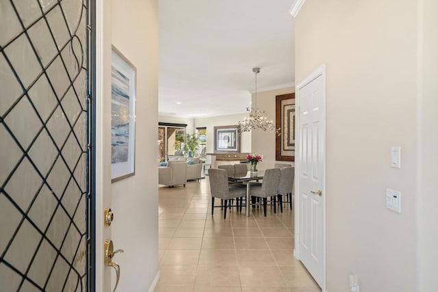 interior space with light tile patterned flooring, ornamental molding, and a chandelier