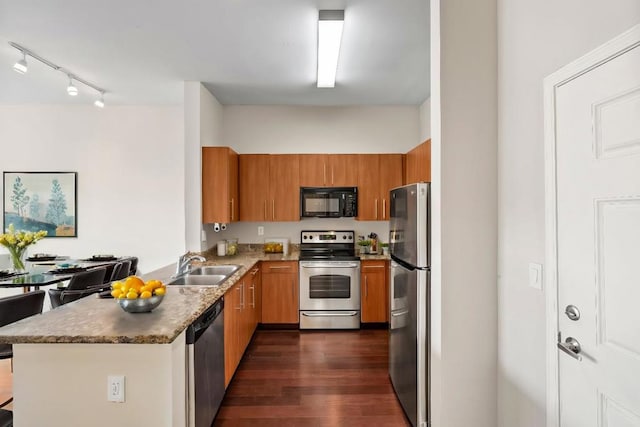 kitchen with stainless steel appliances, dark wood-type flooring, and sink