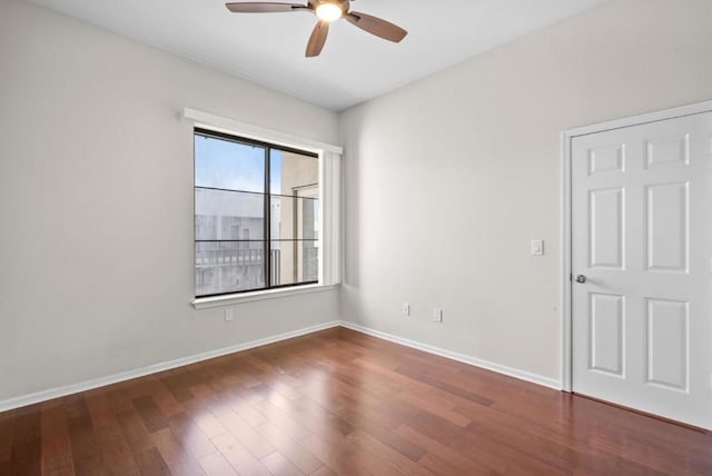 unfurnished room featuring ceiling fan and dark hardwood / wood-style flooring