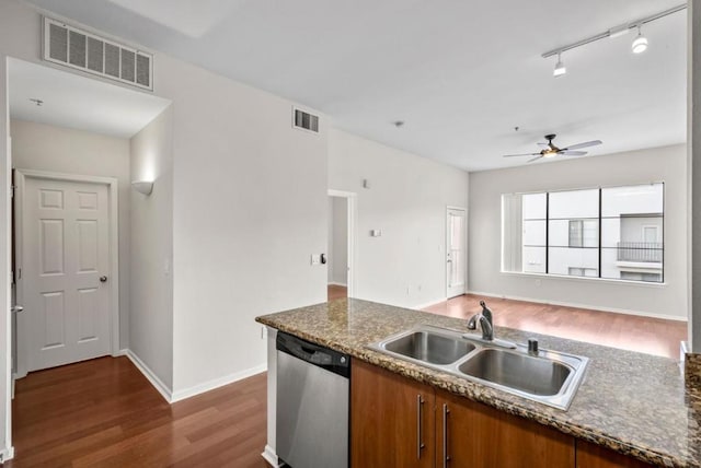 kitchen featuring rail lighting, sink, dark hardwood / wood-style flooring, dishwasher, and ceiling fan