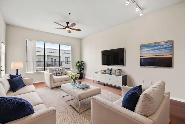 living room featuring ceiling fan, wood-type flooring, and rail lighting