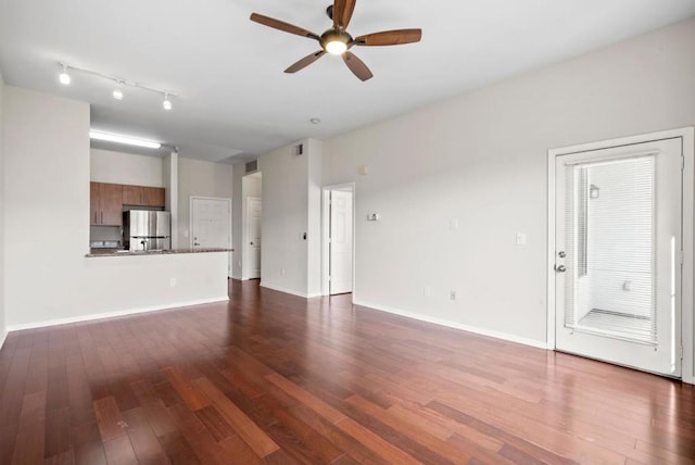 unfurnished living room with ceiling fan and dark hardwood / wood-style floors