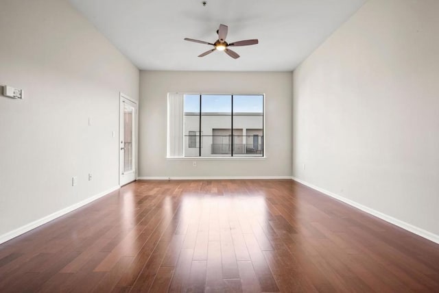 spare room with dark wood-type flooring and ceiling fan