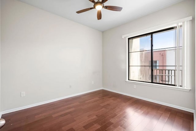 spare room featuring ceiling fan and dark hardwood / wood-style flooring