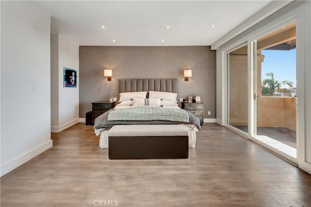 bedroom featuring hardwood / wood-style flooring and access to exterior