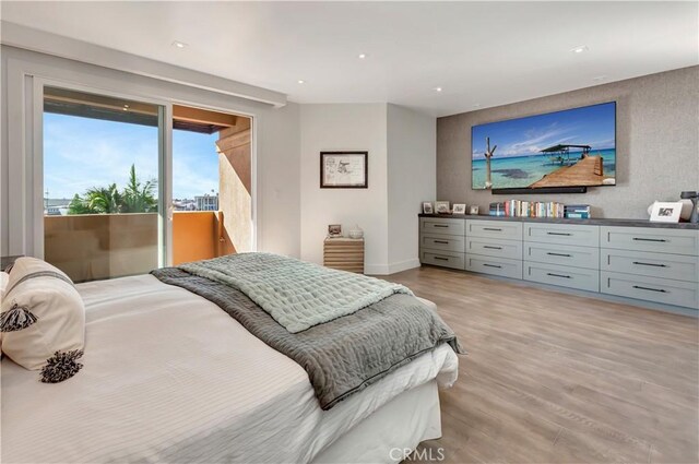 bedroom with light wood-type flooring and access to outside