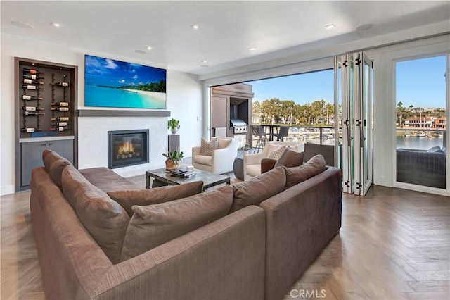 living room with parquet flooring and a healthy amount of sunlight