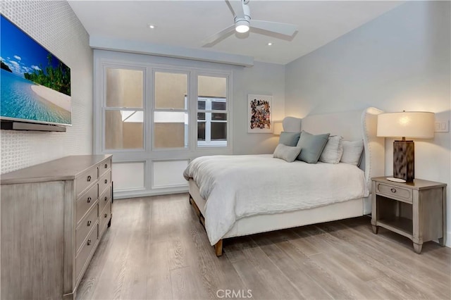 bedroom with ceiling fan and light hardwood / wood-style floors