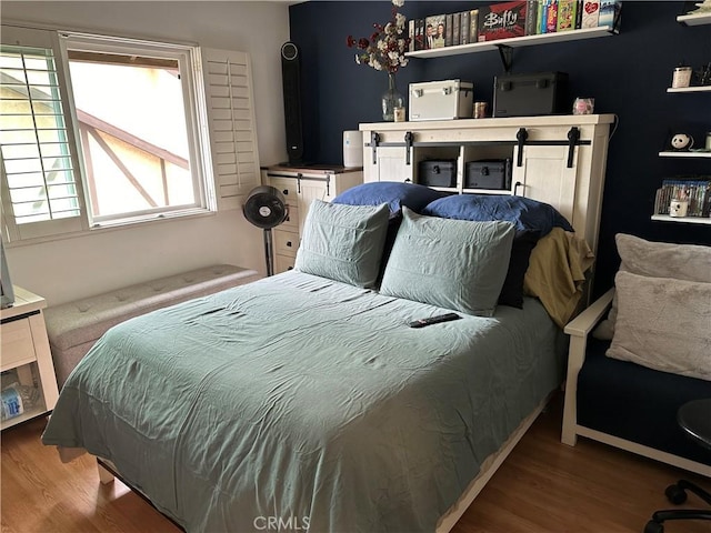 bedroom with hardwood / wood-style floors