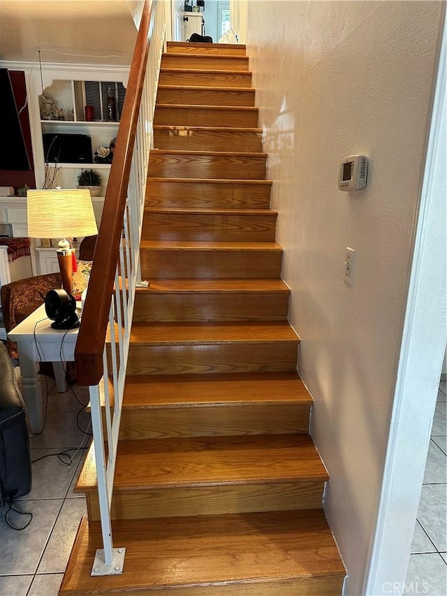 stairway featuring tile patterned floors