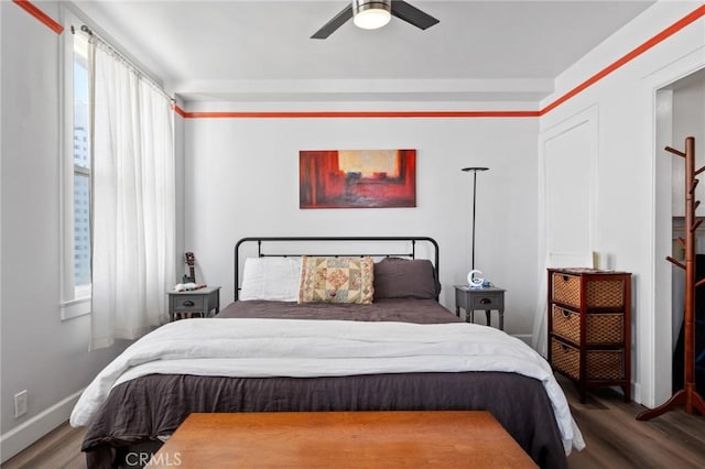 bedroom with ceiling fan and wood-type flooring