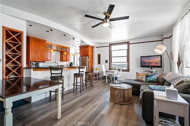 living room with wood-type flooring and ceiling fan