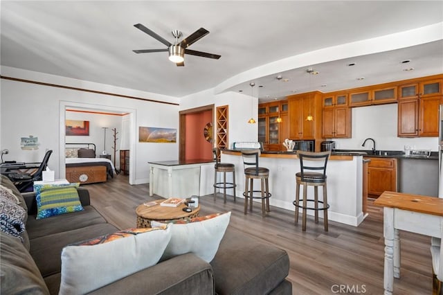 living room with dark hardwood / wood-style flooring and ceiling fan