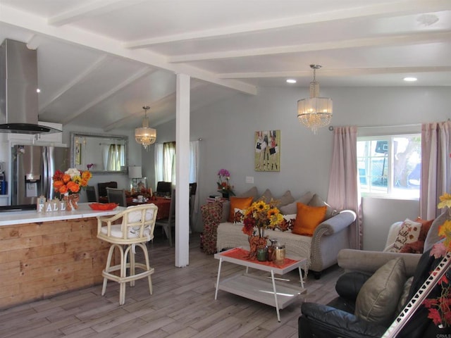 living room with vaulted ceiling with beams, light hardwood / wood-style floors, and a notable chandelier