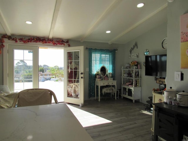 dining space featuring vaulted ceiling with beams, plenty of natural light, and dark hardwood / wood-style floors