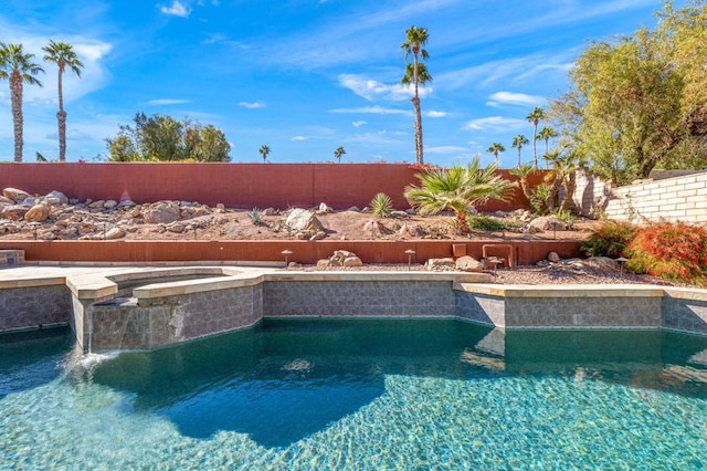 view of pool with pool water feature and an in ground hot tub