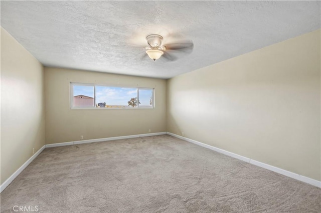 carpeted empty room with a textured ceiling and ceiling fan