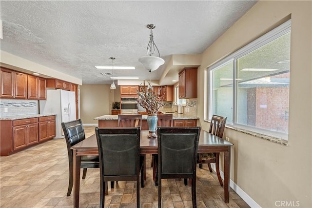 dining room with sink and a textured ceiling