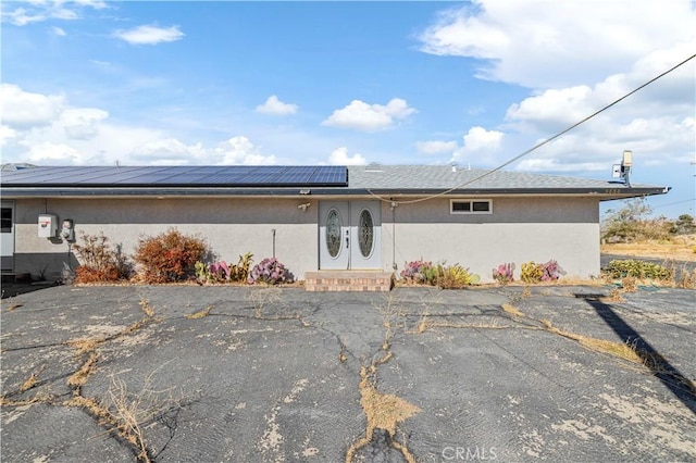 ranch-style house with solar panels