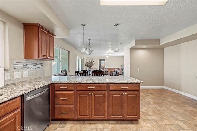 kitchen with a textured ceiling, kitchen peninsula, stainless steel dishwasher, and decorative light fixtures