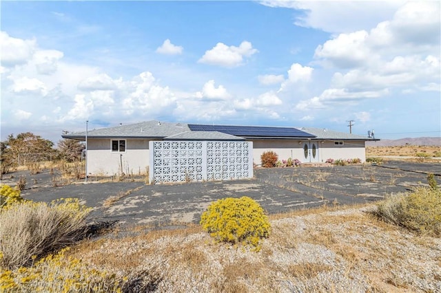 view of property exterior featuring solar panels