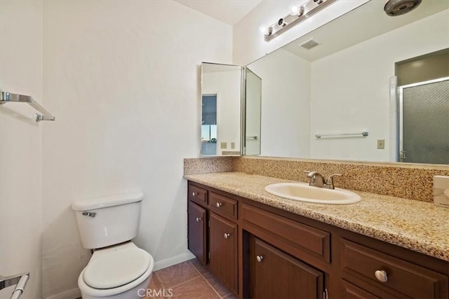 bathroom featuring tile patterned floors, vanity, toilet, and an enclosed shower