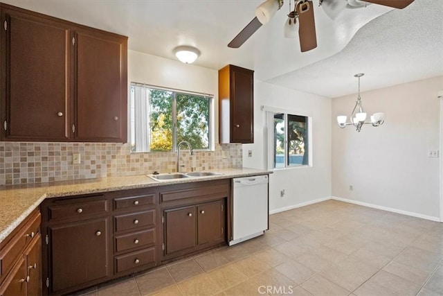 kitchen with white dishwasher, ceiling fan with notable chandelier, sink, decorative backsplash, and decorative light fixtures