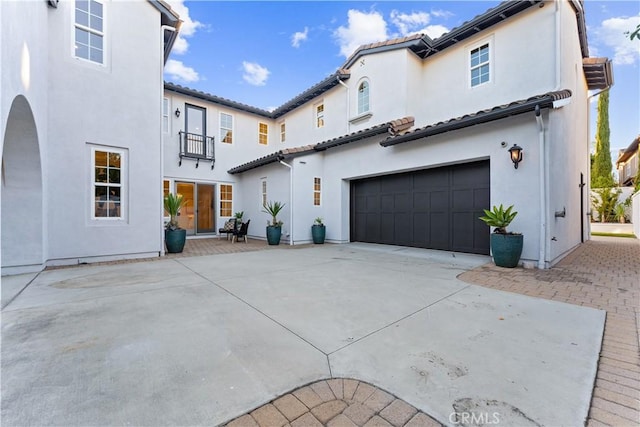 rear view of house with a garage