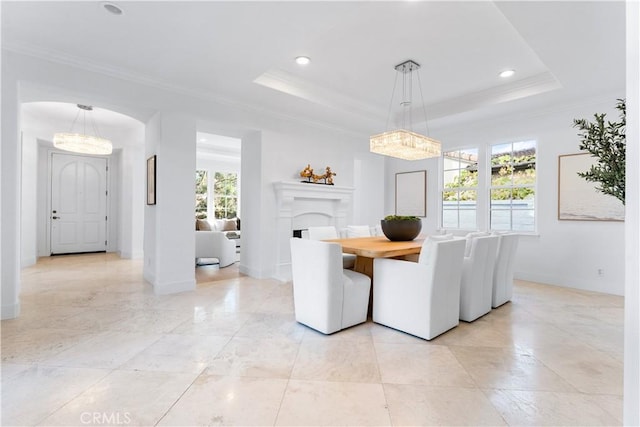 unfurnished dining area with a raised ceiling and ornamental molding