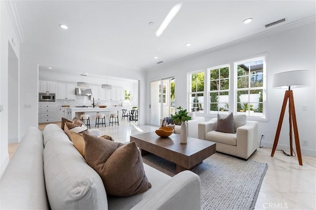 tiled living room featuring crown molding and plenty of natural light