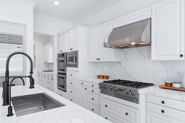 kitchen with white cabinetry, wall chimney exhaust hood, and sink