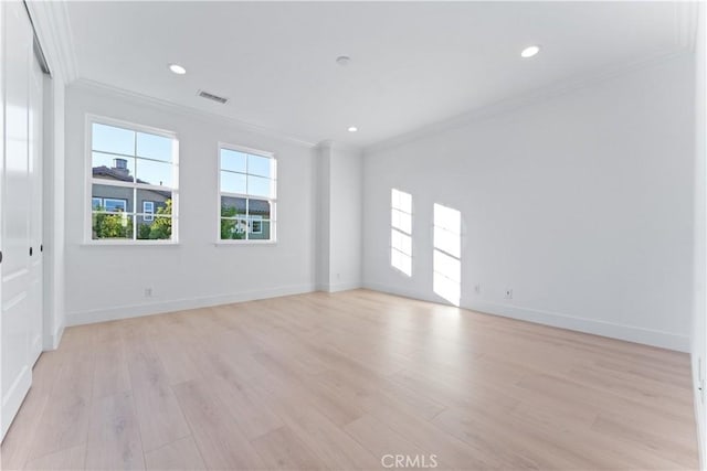 spare room with light hardwood / wood-style flooring and ornamental molding