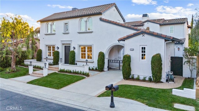 mediterranean / spanish-style house featuring a front lawn