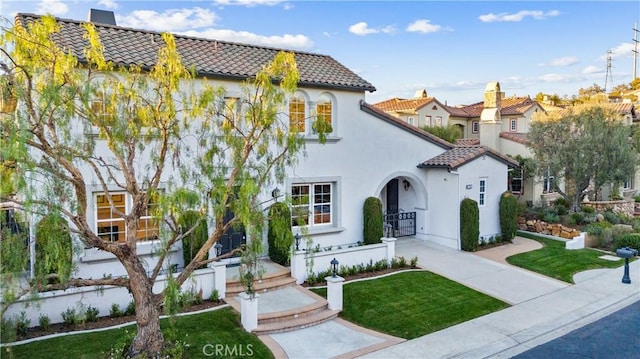 mediterranean / spanish home featuring a front yard