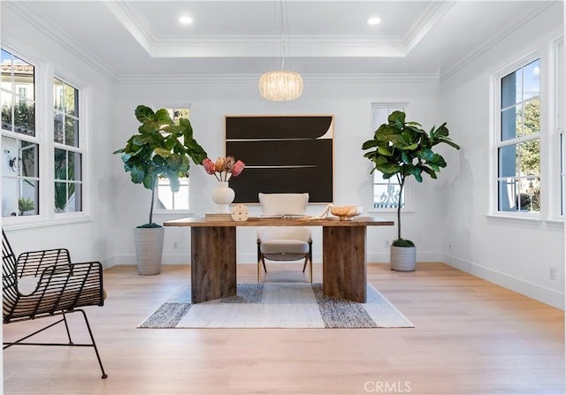 office area featuring a raised ceiling, light hardwood / wood-style flooring, and ornamental molding